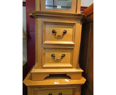 A light oak two drawer bedside table