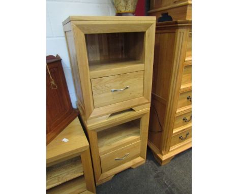A pair of light oak bedside cabinets with alcoves and single drawer