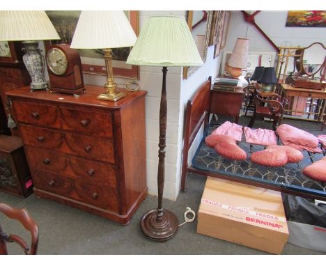 A mahogany standard lamp with carved detail of Chinese figures and palm trees, green pleated shade