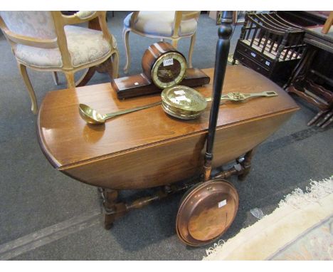 A modern Ercol medium oak drop-flap gate-leg coffee table