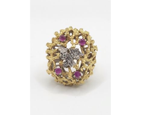 An unusual mid to late 20th century yellow gold, diamond, and ruby cocktail ring, the textured naturalistic mount inset with 