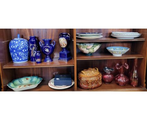 A group of various ceramic and cranberry glass items, a treacle glazed food dish, etc. 