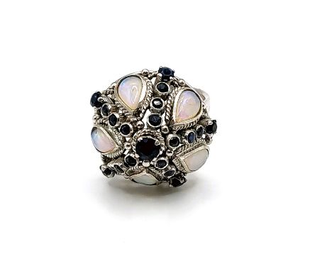 A 14ct white gold, opal, and sapphire ring, of dombed bombe design, inset with pear-cut opals and a star-shaped setting of sa