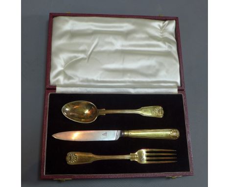 A George IV Paul Storr silver gilt knife, fork and spoon set. Having Kings pattern and housed inside a maroon velvet lined ca