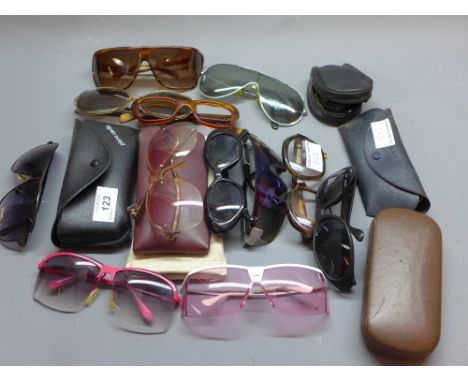 A pair of Pierre Cardin sunglasses together with a large collection of vintage sunglasses and cases.