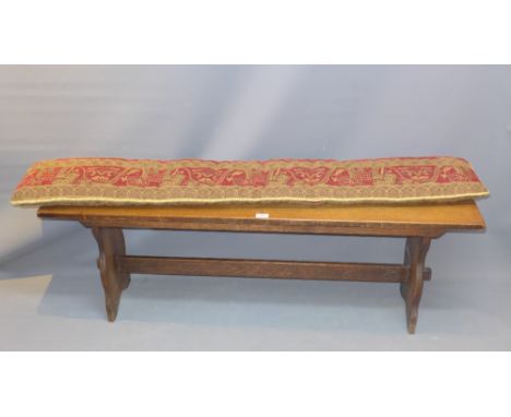 A 19th Century oak bench raised on tresset supports jointed by stretcher