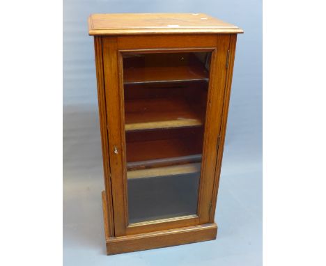 A 19th century oak display cabinet with glazed door enclosing shelf space and raised on stepped base. H-103cm W-55cm D-40cm.