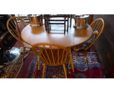 A 20th Century Ercol elm dining table and four stick back chairs 104cm x 120cm 