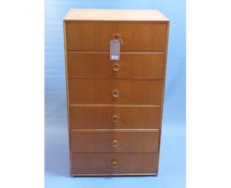 An early 20th Century light oak pedestal chest of six drawers raised on bun feet, H:108cm W:61cm D:46cm
