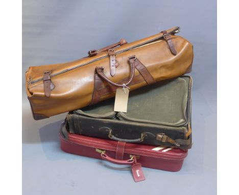 A vintage red leather Harrod's suitcase together with a vintage cricket bag and a canvas suit carrier. 