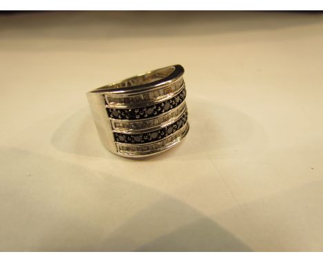 A baguette cut white and black diamond ring. Size N, stamped 925                    
