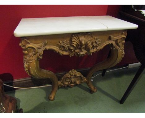 A 19th Century gilt wood console table, shell and scrolled foliate relief, marble top split. 77cm x 73cm x 34cm