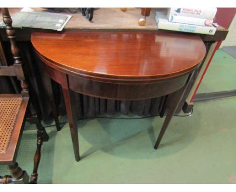 A George III mahogany bow front card table with satinwood line and ebony inlay on square tapering legs, 73cm high