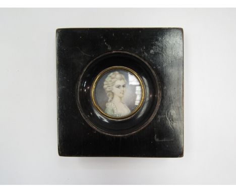 A Victorian miniature oil on ivory portrait with ebonised frame, 4.3cm diameter