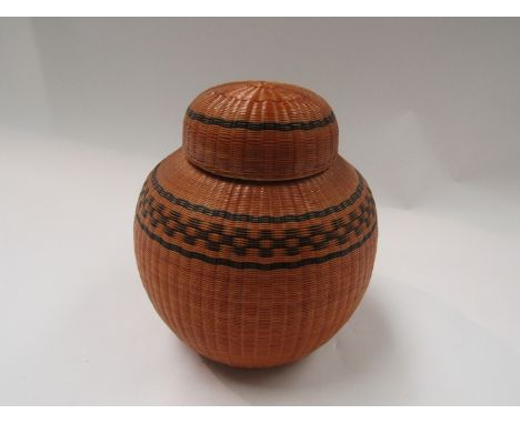 An Oriental ceramic ginger jar covered in fine canework, 12cm tall, marks to base
