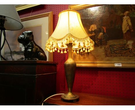 A brass table lamp with eastern pattern and shade. 50cm tall