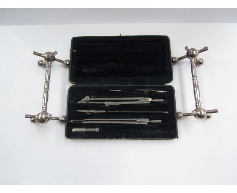 A cased compass set and a pair of plated knife rests