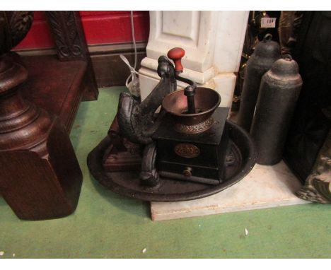 A cast boot scraper, weight, coffee grinder and flat iron