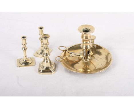 A 19th Century brass chamber stick with snuffer and wick trimmer, a pair of brass candlesticks and a 19th Century brass minia