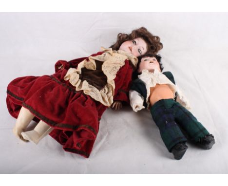 An Armand & Marseille bisque headed doll with jointed composition body and red lace trimmed velvet dress, 26" high, and a sim