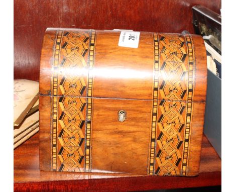 A rectangular two-compartment dome top tea caddy decorated parquetry bands, a set of four floral painted wooden figure plates