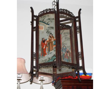 An oriental hexagonal hardwood framed lantern inset glass panels painted figures, 27" high (two panels damaged)