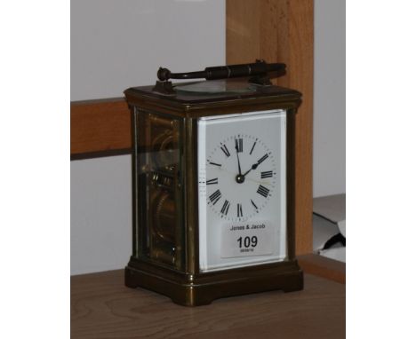 A brass cased carriage clock with white enamel dial (crack to dial)