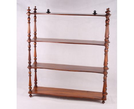 A Victorian walnut serpentine front four-tier open wall shelf, 26" wide