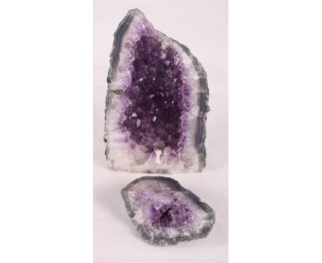 A cut and polished amethyst geode, 10 1/2" high, and two desert roses