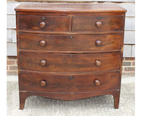 An early 19th Century mahogany bowfront chest of two short and three long graduated drawers with knob handles, on bracket sup