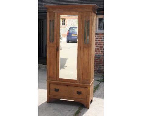An Edwardian mahogany wardrobe enclosed panelled doors, on bracket supports, 40" wide