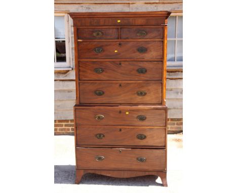 A George III mahogany tallboy, the upper section with canted corners fitted two small and three long drawers over three furth