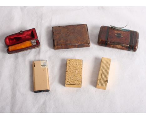 A Calibri cigarette lighter in gilt metal case, two other cigarette lighters, two wooden snuff boxes and a gold mounted amber