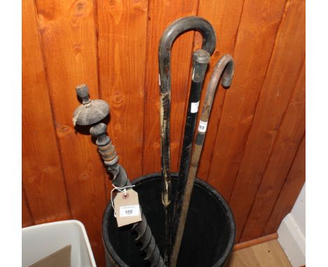A continental spiral turned walking stick, a silver mounted walking stick, a horn walking stick and a silver mounted evening 