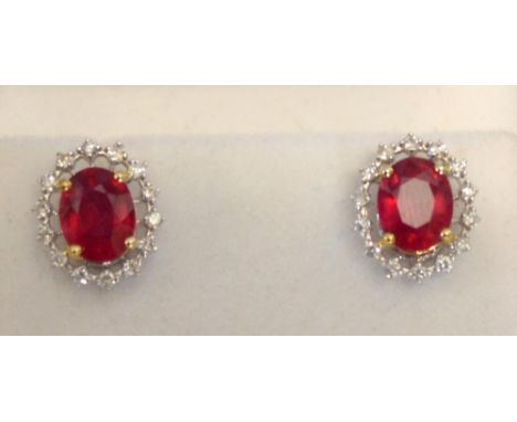 A Pair of 18ct. White Gold Treated Ruby and Diamond Cluster Earrings, rubies approximately 4.65 ct, diamonds approximately 0.