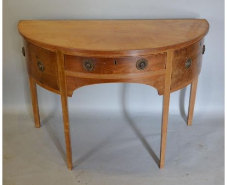 A 19th Century Mahogany Demi-Lune Serving Table, the chequer line inlaid top above a central drawer flanked by bow doors with