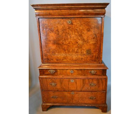 An Early 18th Century Walnut Escritoire, the moulded cornice above a concealed frieze drawer, the fall front enclosing a fitt