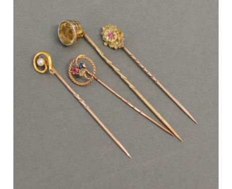 A 15ct. Gold Ruby Set Stick Pin  together with three other similar 