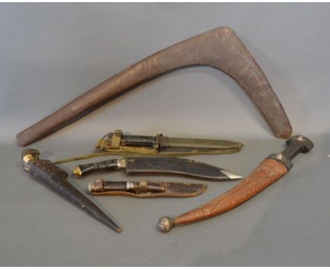 A Military Knife with Scabbard together with a collection of others to include a Khukuri knife and a Boomerang 