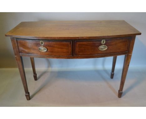 A 19th Century Mahogany Bow Fronted Serving Table, the chequer inlaid top above two frieze drawers with oval brass handles ra