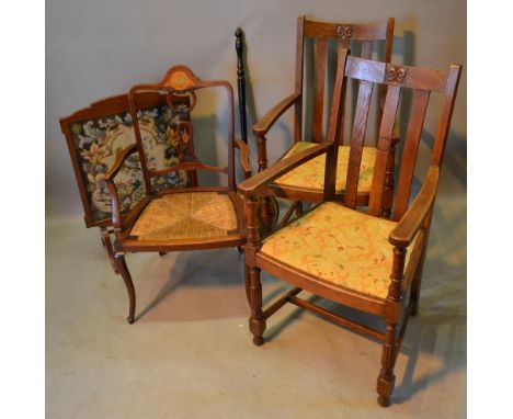 An Edwardian mahogany marquetry inlaid armchair together with a pair of early 20th century oak armchairs a fireguard and a wa