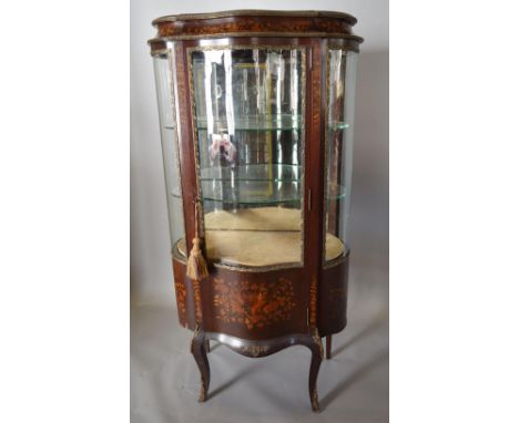 A Late 19th Early 20th Century French Marquetry Inlaid and Gilt Metal Mounted Vitrine, the serpentine glazed door enclosing g