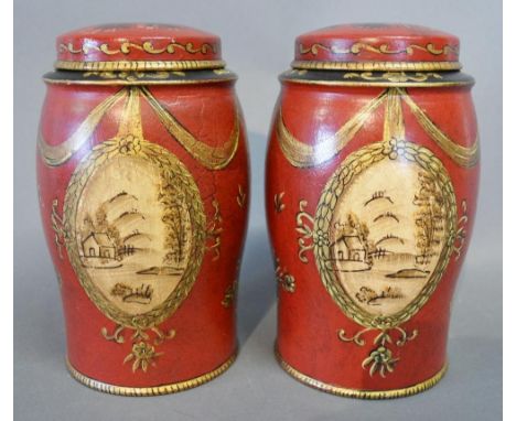 A Pair of Tole Ware Small Covered Canisters with gilded bow and ribbon decoration upon a red and black ground, 17 cms tall 