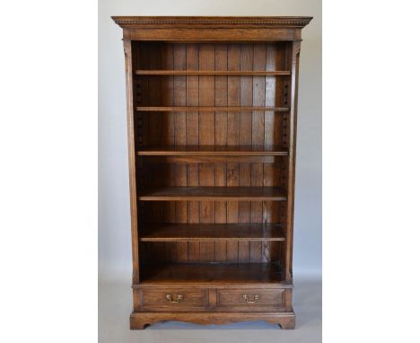 A Good Quality Reproduction Oak Bookcase with an arrangement of Shelves above two drawers raised upon bracket feet, 105 cms w