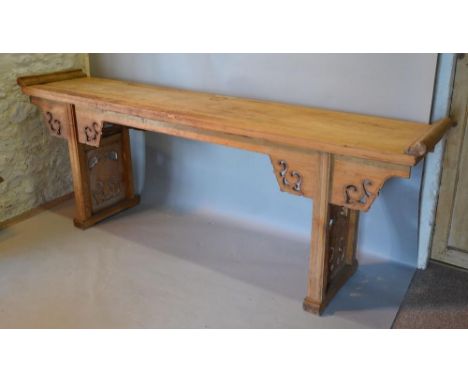 A Chinese Large Altar Table with Scroll Ends and Pierced Frieze and pierced end supports, 250 cms wide, 49 cms deep, 94 cms h