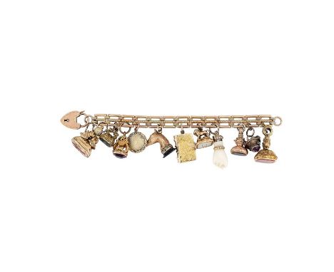 A Victorian gold engraved gate bracelet circa 1890, hung with various 19th century seals and charms
The seals mostly mid 19th