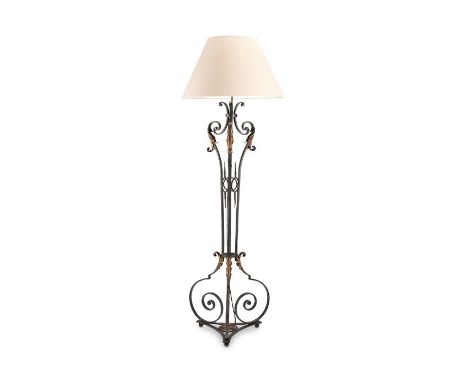 A 1940's cast iron black painted and parcel gilt standard lamp after Gilbert Poillerat
On scrolling supports and base, fitted