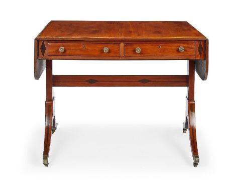 A Regency mahogany and rosewood crossbanded sofa table
Inlaid with ebony lozenge, line and dot marquetry, the rounded rectang