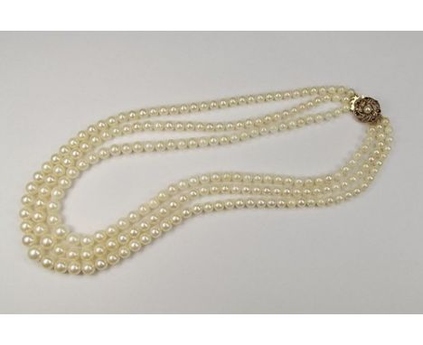 CULTURED PEARLS.
A triple strand cultured pearl necklace, with 9ct. gold pearl & garnet clasp. Bead size 5mm to 9mm.