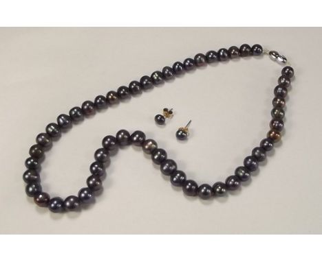 PEARL SET.
A South China Sea, 53 bead cultured black pearl necklace & matching ear studs.
